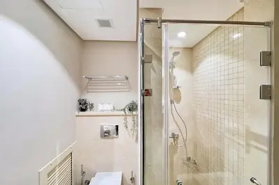 a bathroom with a shower with a glass door at Peaceful & Placid 1 BDR Mangroovy Free Pool & Beach in Hurghada