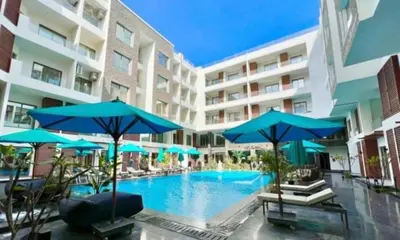 a swimming pool with blue umbrellas in a hotel at Imperial Beach Resort in Hurghada