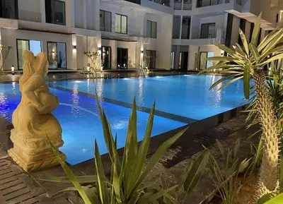 a swimming pool with a bear statue in front of a building at Imperial Beach Resort in Hurghada