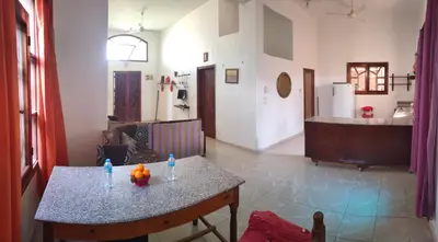 a living room with a table and a kitchen at Pro Luxor guest house in Luxor