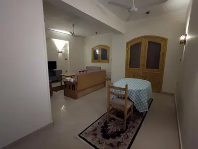 a living room with a table and a couch at Pharaohs Apartments in Luxor