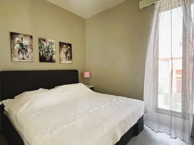 a bedroom with a white bed and a window at Luminous 4BR Villa, Free Pool & Lagoon Access At Gouna in Hurghada