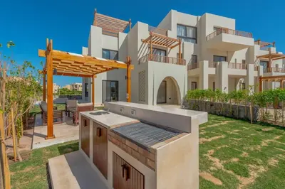 a house with a outdoor kitchen in front of it at Comfy 2BR in Shedwan El Gouna Garden BBQ, Pool, Lagoon in Hurghada