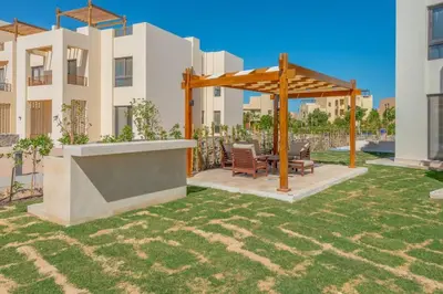 a gazebo in a yard in front of a building at Comfy 2BR in Shedwan El Gouna Garden BBQ, Pool, Lagoon in Hurghada