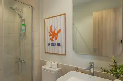 a bathroom with a shower and a toilet and a sink at Charming 2-Lvl 3BR Lagoon Home in Shedwan El Gouna, Pool Access in Hurghada