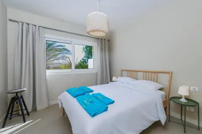 a bedroom with a white bed and a window at Beautiful apartment with roof terrace in Joubal in Hurghada