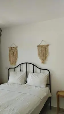 a bed with white sheets and pillows in a bedroom at Studio El Gouna G Cribs Hotel in Hurghada