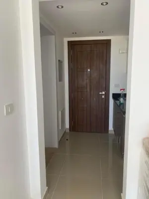 a hallway with a wooden door in a house at Studio El Gouna G Cribs Hotel in Hurghada