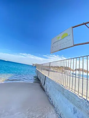 a fence on the beach next to the ocean at Esplanada hotel Apartments in Hurghada
