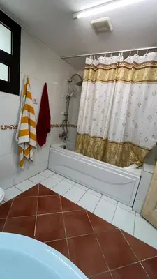 a bathroom with a tub and a shower at Esplanada hotel Apartments in Hurghada
