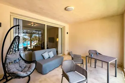 a living room with a couch and a table at Summer Breeze 2 BDR Pool Sea View Mangroovy in Hurghada