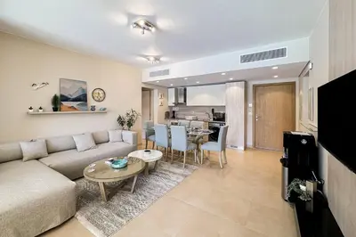 a living room with a couch and a table at Summer Breeze 2 BDR Pool Sea View Mangroovy in Hurghada