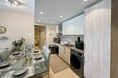 a kitchen with a table and a dining room at Summer Breeze 2 BDR Pool Sea View Mangroovy in Hurghada