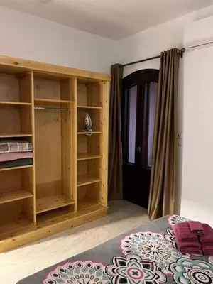 a room with a bed and a closet at Villa Muhammad in Quseir