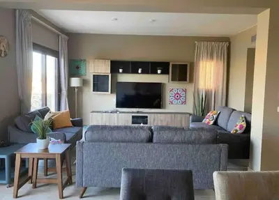 a living room with a couch and a tv at Water front luxury 3BD villa in Hurghada