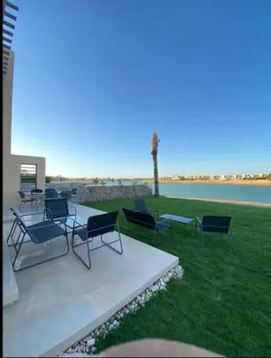 a group of chairs and tables on a patio at Water front luxury 3BD villa in Hurghada