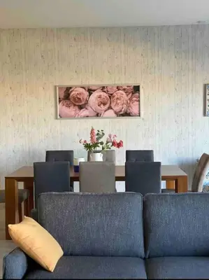 a living room with a couch and a table with flowers at Water front luxury 3BD villa in Hurghada