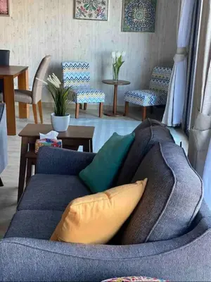 a living room with a blue couch with pillows at Water front luxury 3BD villa in Hurghada
