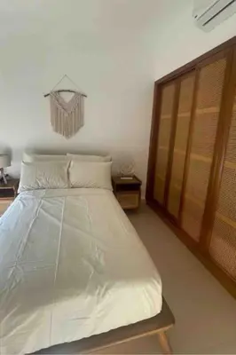 a bedroom with a bed and a wooden door at 3 Bedrooms with roof in Makadi in Hurghada
