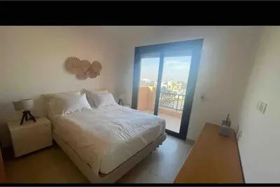 a bedroom with a bed and a window with a balcony at 3 Bedrooms with roof in Makadi in Hurghada