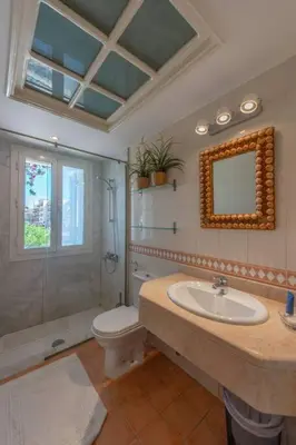 a bathroom with a sink and a toilet and a mirror at Luxury apartment on the Marina in Hurghada