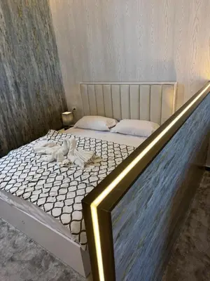 a bedroom with a bed with white sheets and pillows at Mastaba Village Hurgada House in Hurghada