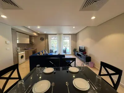 a dining table in a living room with a couch at M Residence with Pool View & Beach Access - El Gouna, Hurghada in Hurghada