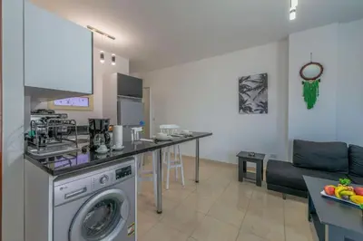 a kitchen and living room with a washing machine at Luxury apartment on the pool in Hurghada