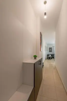 a hallway with white walls and a counter in a room at Luxury apartment on the pool in Hurghada
