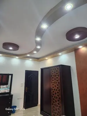 a room with two doors and a ceiling with lights at Abeer Suites 5 in Hurghada