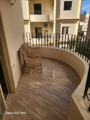 a chair sitting on the balcony of a building at Abeer Suites 5 in Hurghada