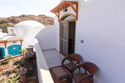 a view of a house with white walls at Aro Kato Nubian Guest House in Aswan