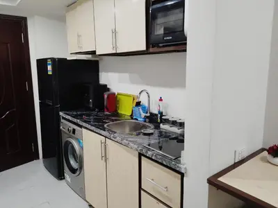 a small kitchen with a sink and a refrigerator at Scandic Resort Hurghada Red Sea in Hurghada
