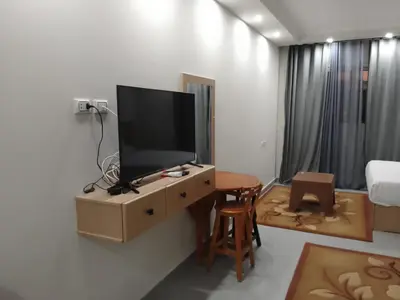 a living room with a tv on a wall at Scandic Resort Hurghada Red Sea in Hurghada