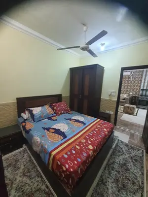 a bedroom with a bed and a ceiling fan at Abeer Suites 4 basement in Hurghada