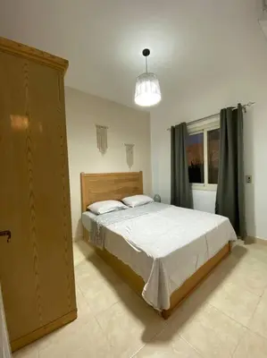 a bedroom with a large bed and a window at Enjoy Makadi Heights Red Sea in Hurghada