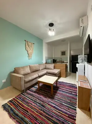 a living room with a couch and a coffee table at Enjoy Makadi Heights Red Sea in Hurghada