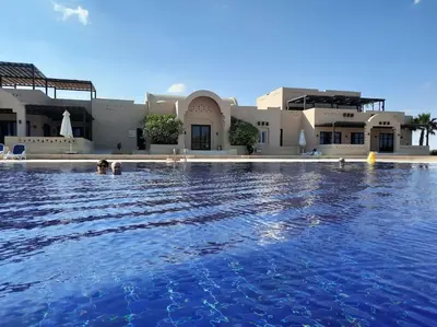 a large swimming pool in front of a building at Relaxing time in Makadi Heights in Hurghada