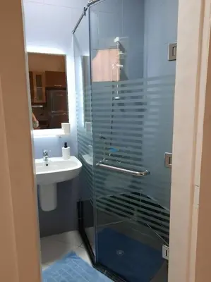 a bathroom with a glass shower and a sink at Relaxing time in Makadi Heights in Hurghada