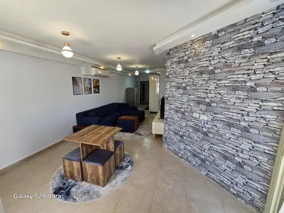 a living room with a stone wall at Sea view Prinessa Resort in Hurghada