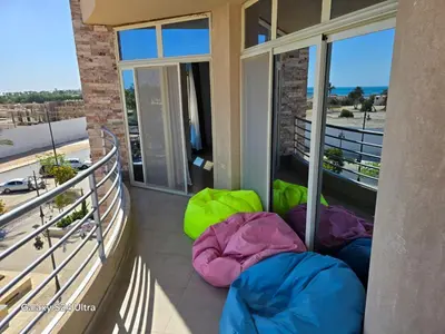 a balcony with three sleeping bags on the floor at Sea view Princessa Resort in Hurghada