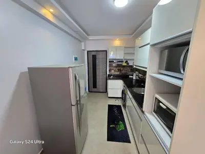 a kitchen with a refrigerator and a sink at Sea view Princessa Resort in Hurghada
