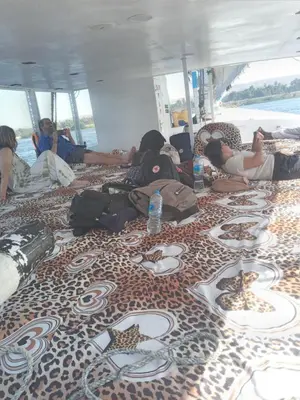 a group of people laying on the floor of a boat at Mama Africa Felucca in Aswan