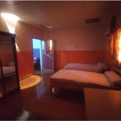 a hotel room with two beds and a window at Ali Toot in Luxor