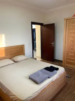 a bedroom with a bed with two towels on it at Beach Side 1 Bedroom Apartment in Hurghada