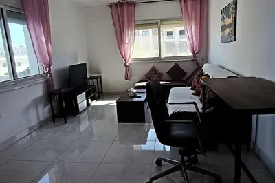 a living room with a desk and a table and a couch at Cozy 1 bedroom Seaview escape in Hurghada