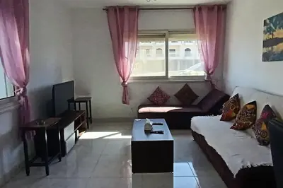 a living room with a couch and a table at Cozy 1 bedroom Seaview escape in Hurghada