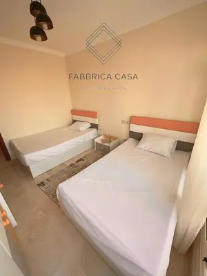 two beds in a room with a sign on the wall at Astonishing Twin Villa in O-C in Coraya Bay
