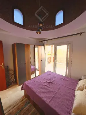 a bedroom with a bed with a purple blanket at Astonishing Twin Villa in O-C in Coraya Bay
