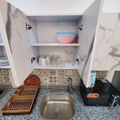 a kitchen counter with a sink in a kitchen at Hurghada Airport Aparthotel - SAHLHOMES in Hurghada